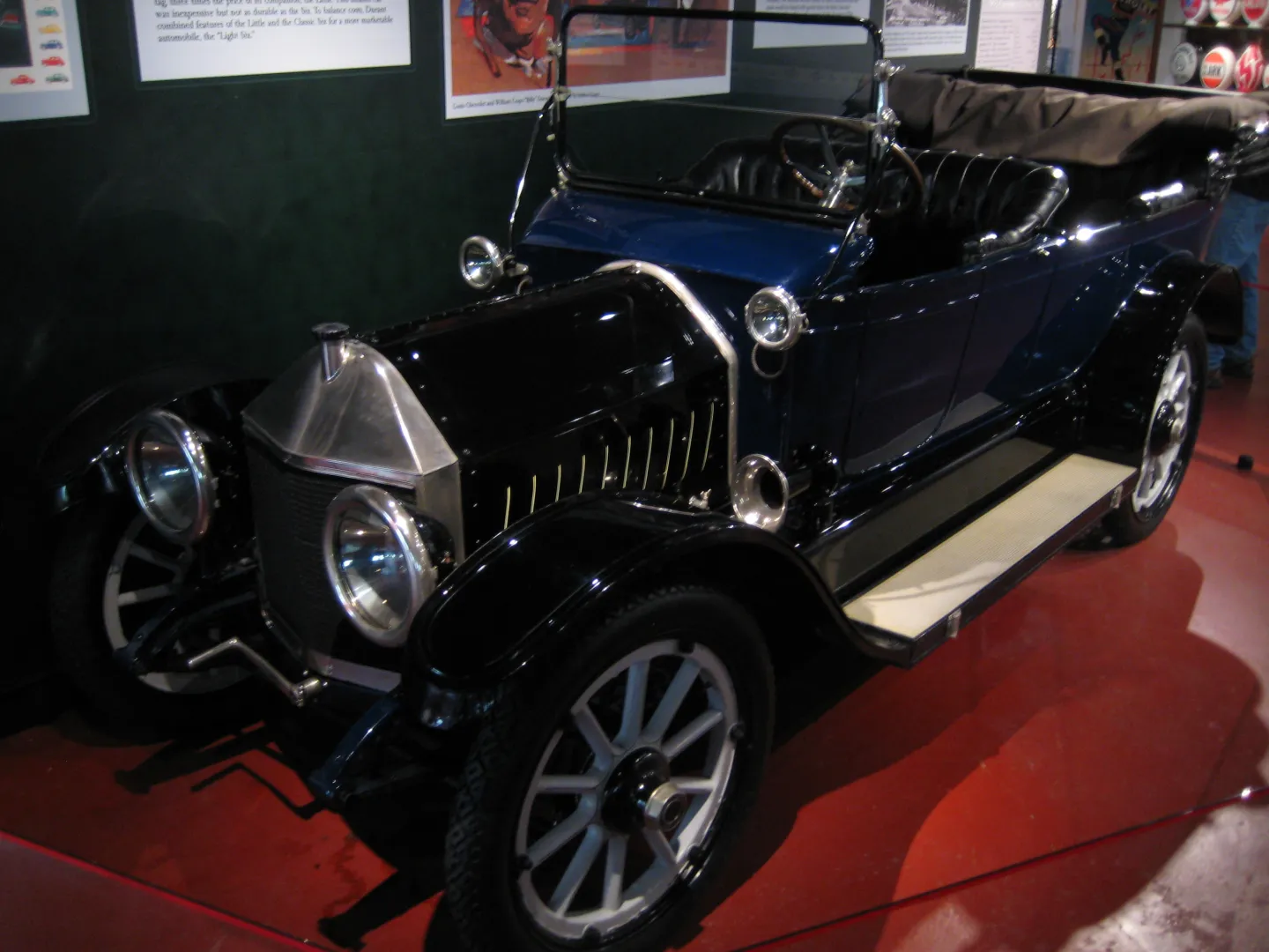 Dark-blue 1913 Chevrolet Classic Six displayed indoors.