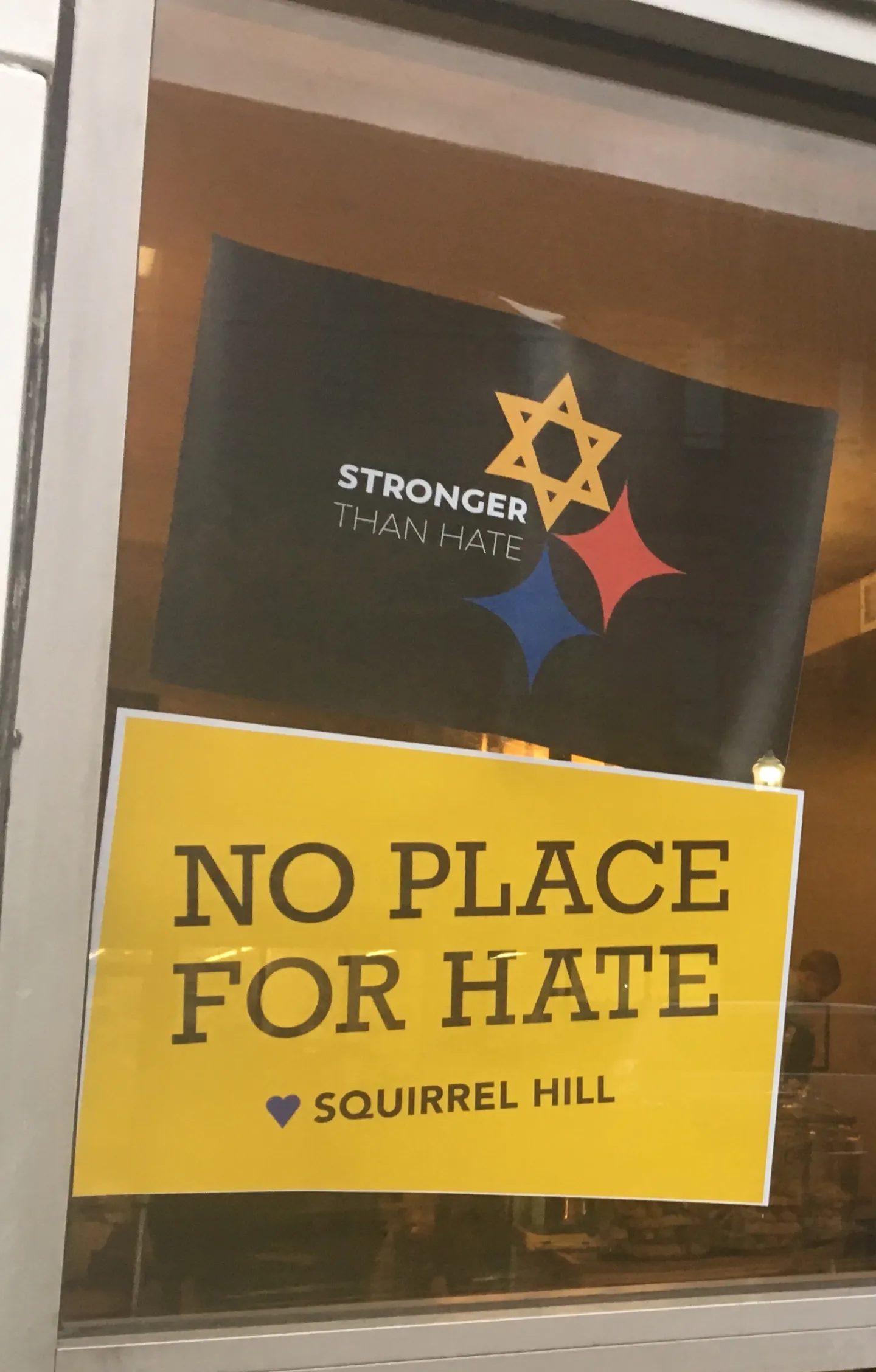 Solidarity posters outside a Squirrel Hill coffee shop after the Tree of Life synagogue shooting.