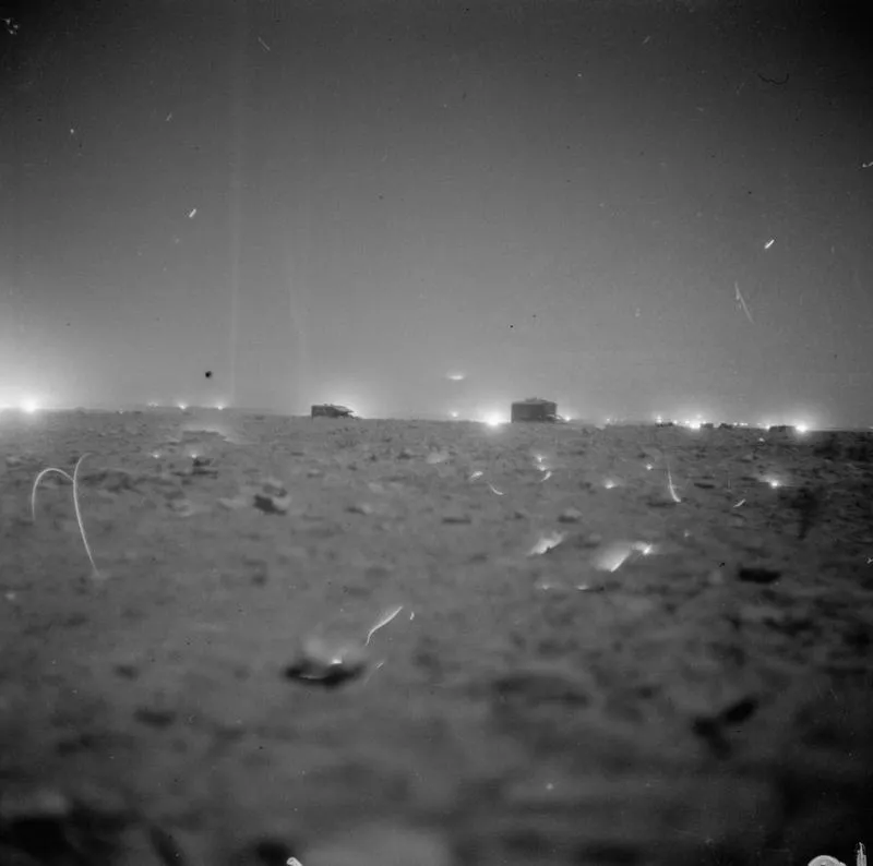 British 25-pounder artillery guns firing during the opening barrage of El Alamein in October 1942