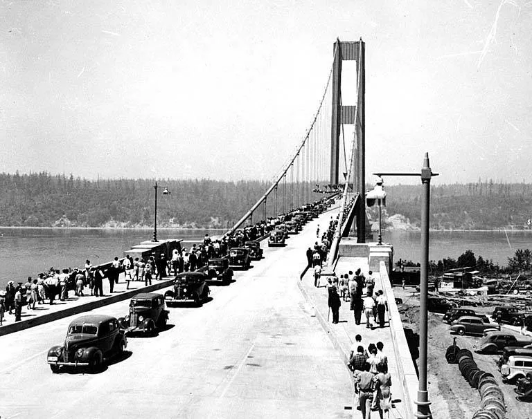 Cars and pedestrians crowd the bridge roadway during its opening celebrations.