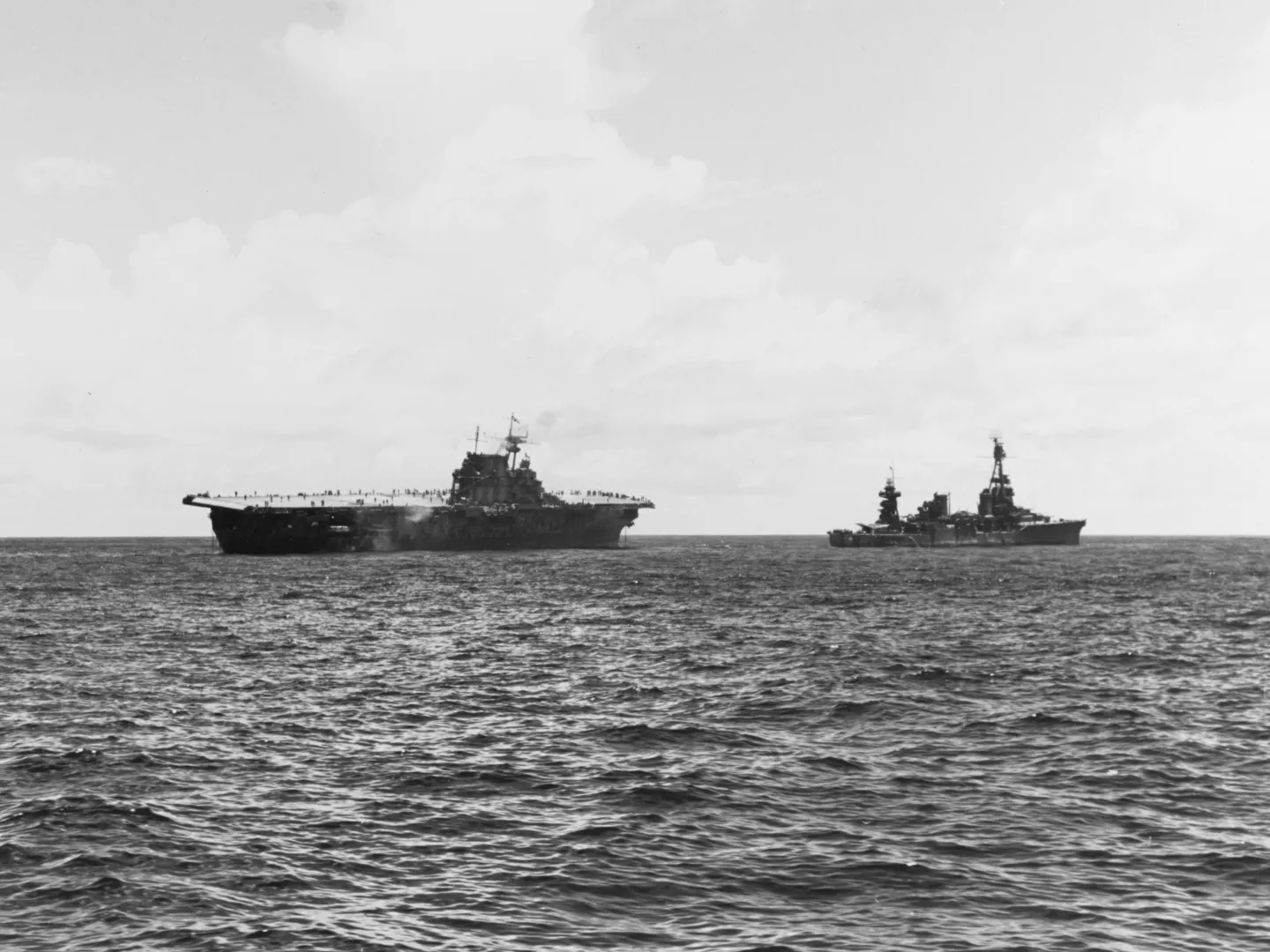 USS Northampton attempting to tow the disabled aircraft carrier USS Hornet in the South Pacific in 1942.