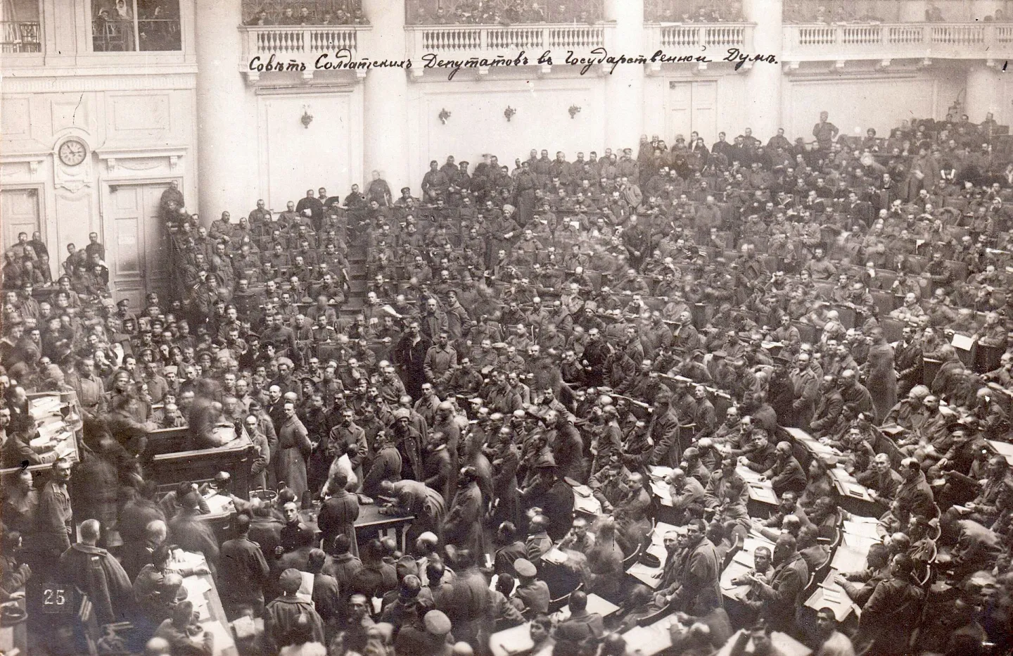 Delegates fill a large assembly hall, with people crowded around the speaker’s area.