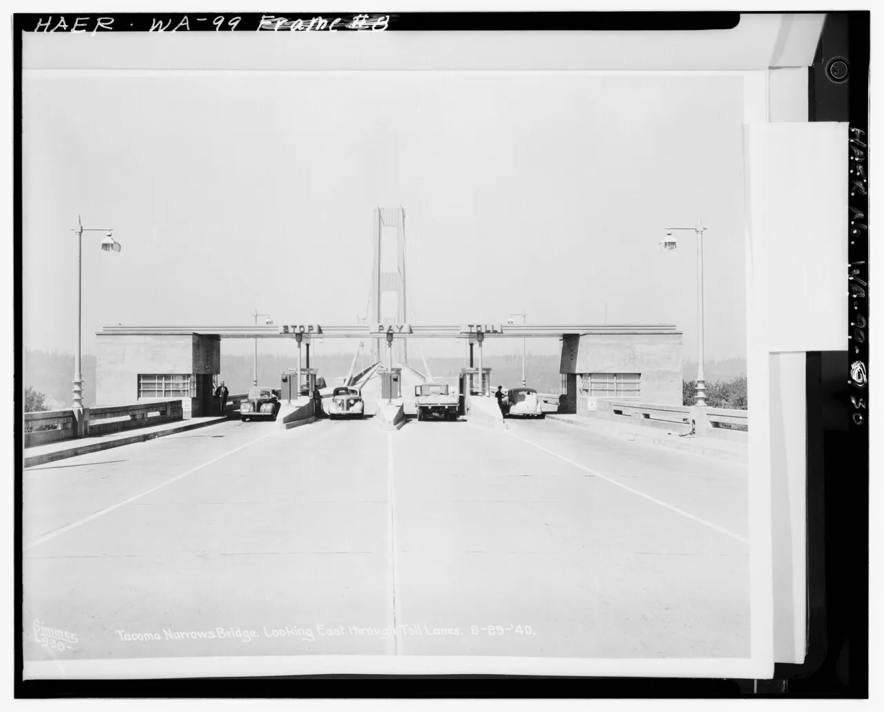 Cars approach the toll booths of the original Tacoma Narrows Bridge in an archival photograph.
