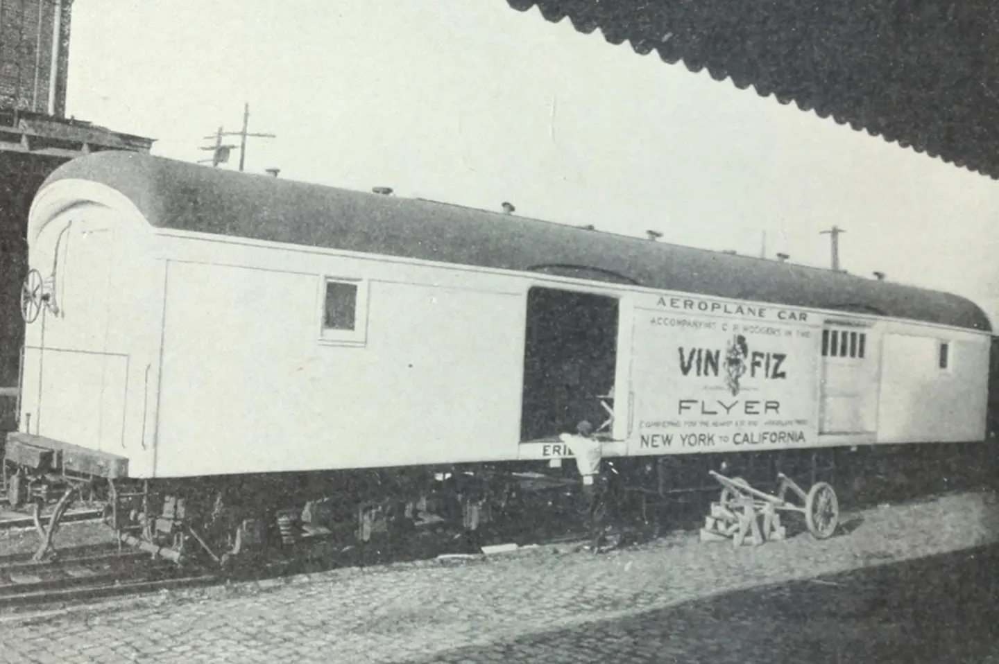 A railway carriage marked Vin Fiz Flyer, with an open door.