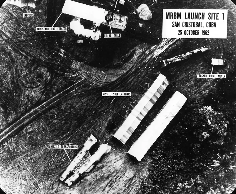 Annotated close aerial view of missile shelter tents, transporters, an erector and vehicle tracks at San Cristóbal on October 25, 1962.