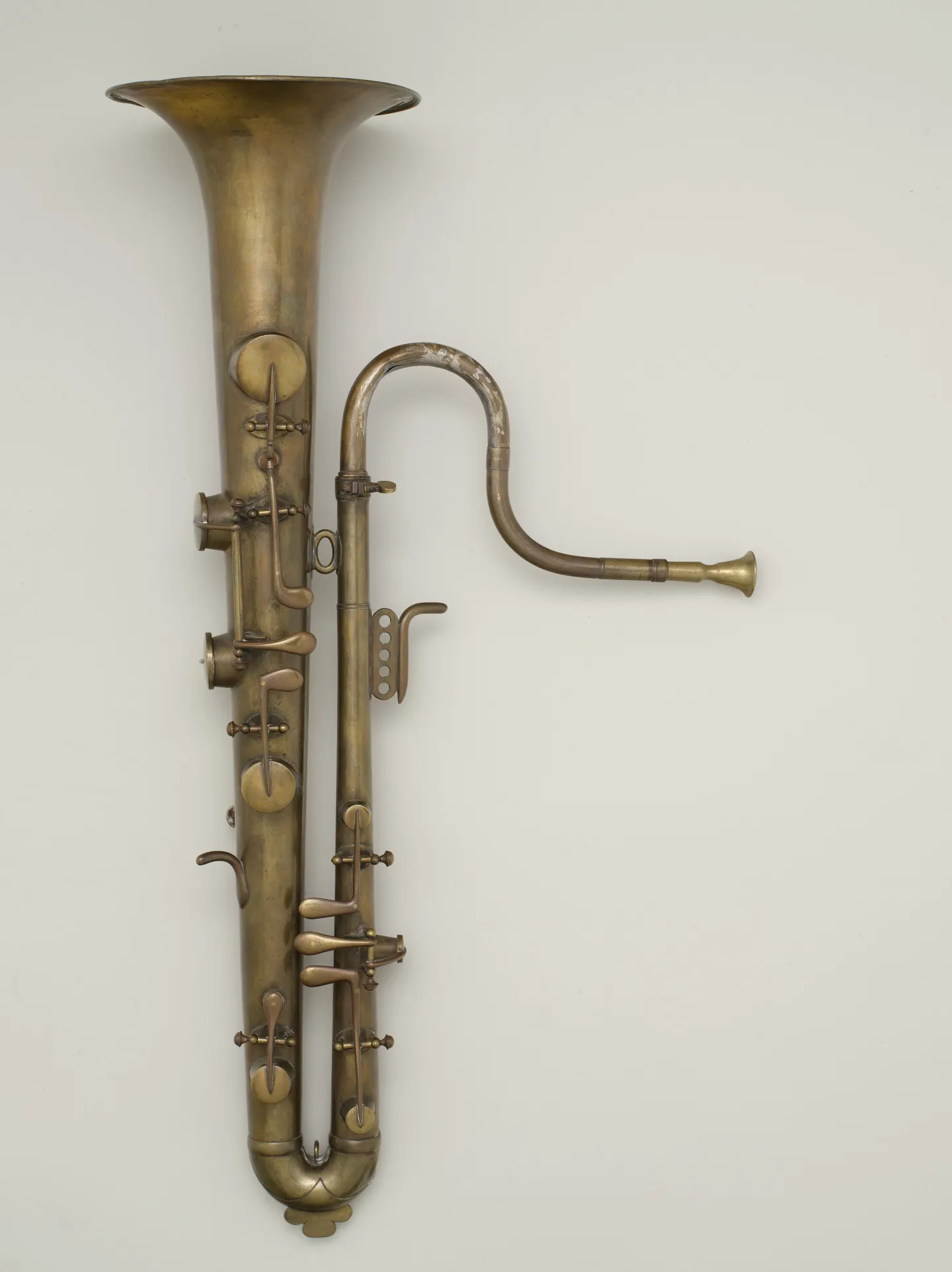 Brass keyed ophicleide with a curved lower tube and upright bell.