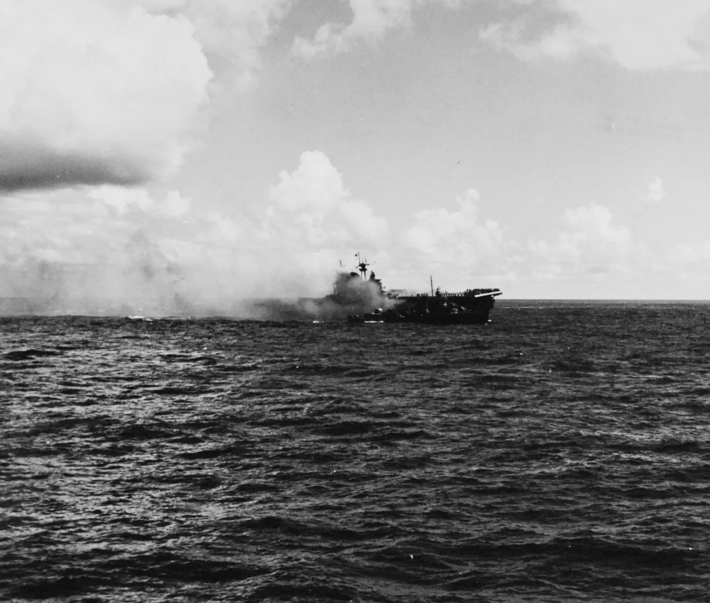 Burning USS Hornet aircraft carrier with a U.S. Navy destroyer alongside, October 26, 1942.