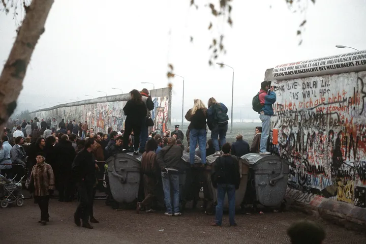 A crowd gathered at a newly cut opening in the Berlin Wall at Potsdamer Platz.