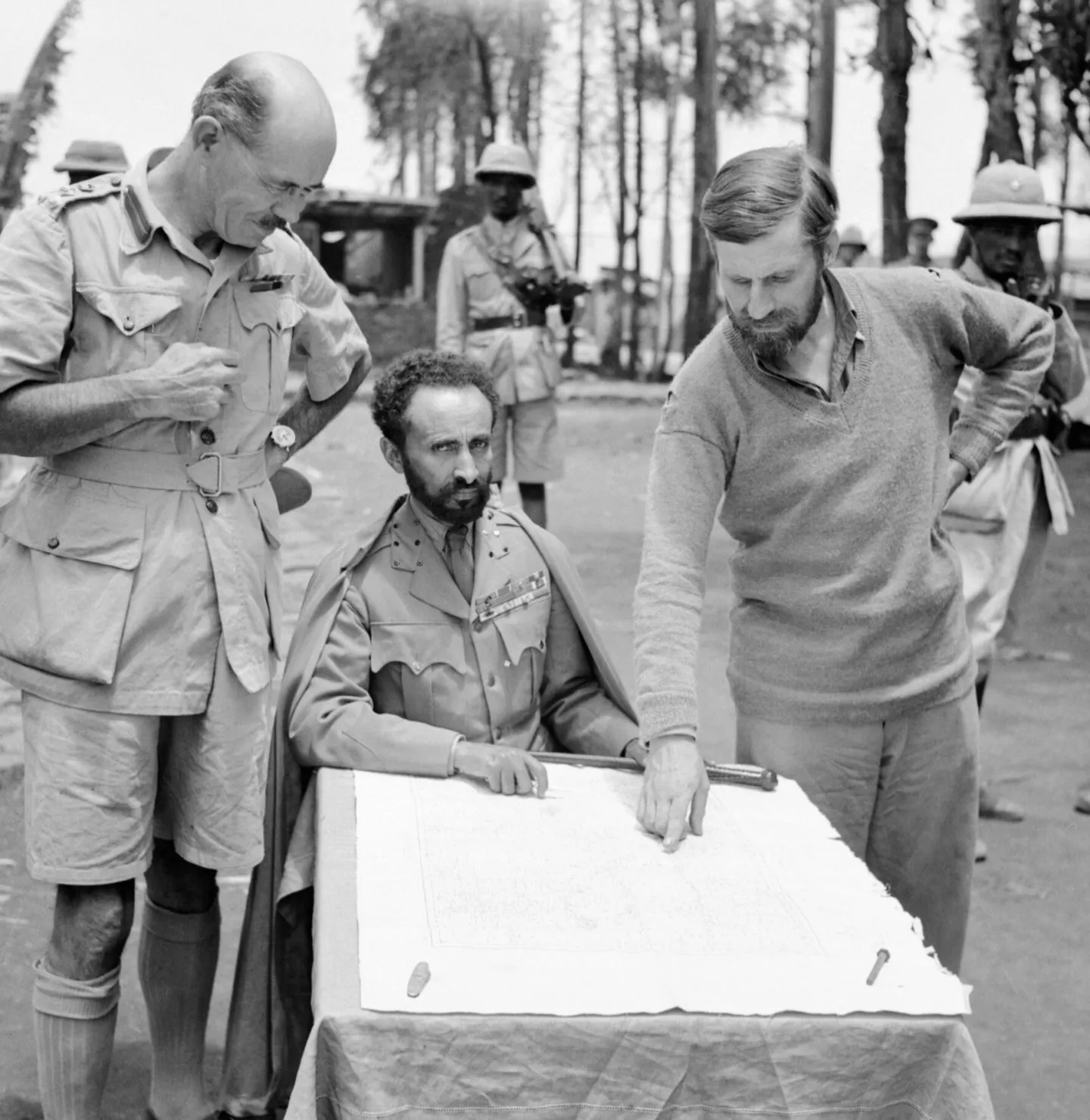 Haile Selassie, Sandford and Wingate consult a map at Dambacha Fort.