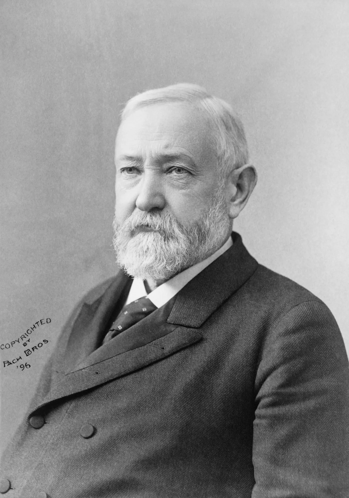 Benjamin Harrison seated in a Pach Brothers studio portrait.