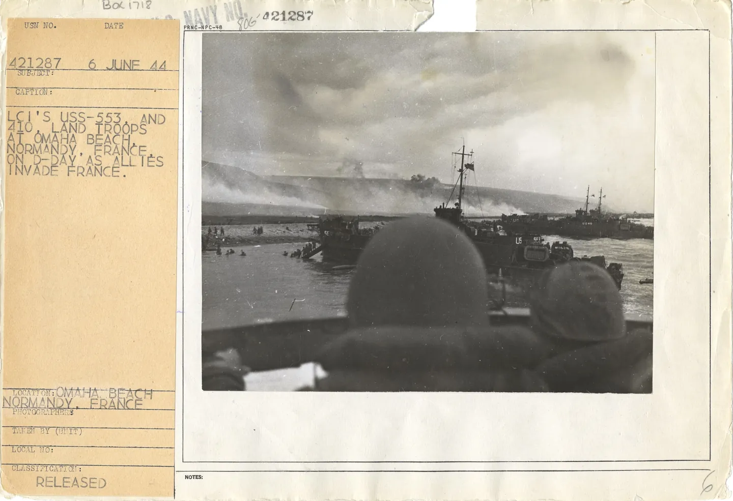 USS LCI(L)-553 and USS LCI(L)-410 landing troops at Omaha Beach, viewed from another landing craft.