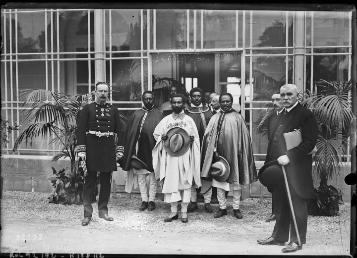 Ras Tafari and officials stand outside a building at Sainte-Assise in 1924.