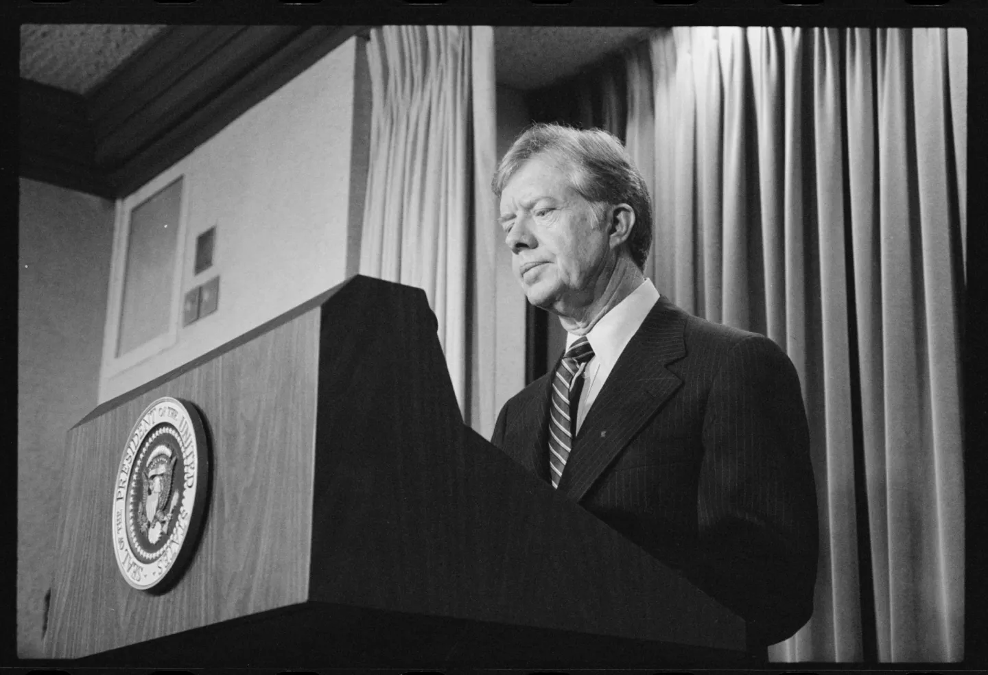 Jimmy Carter speaking at a presidential lectern in April 1980.