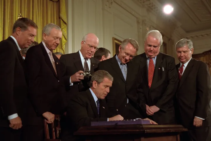 President George W. Bush signs the USA PATRIOT Act at the White House on October 26, 2001.
