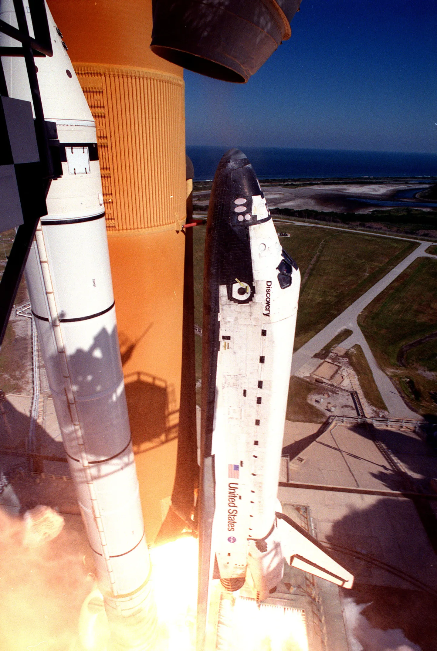 Space shuttle Discovery lifts off on STS-95, trailing exhaust.