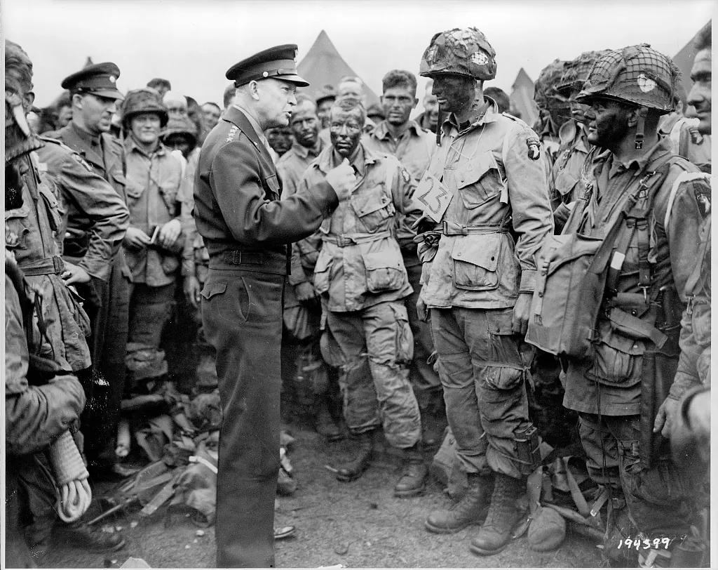 Dwight D. Eisenhower talking with equipped paratroopers of the 101st Airborne Division in England.