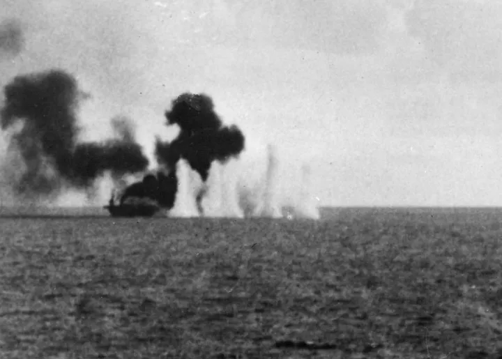 U.S. escort carrier USS Gambier Bay under heavy Japanese shellfire during the Battle off Samar in 1944