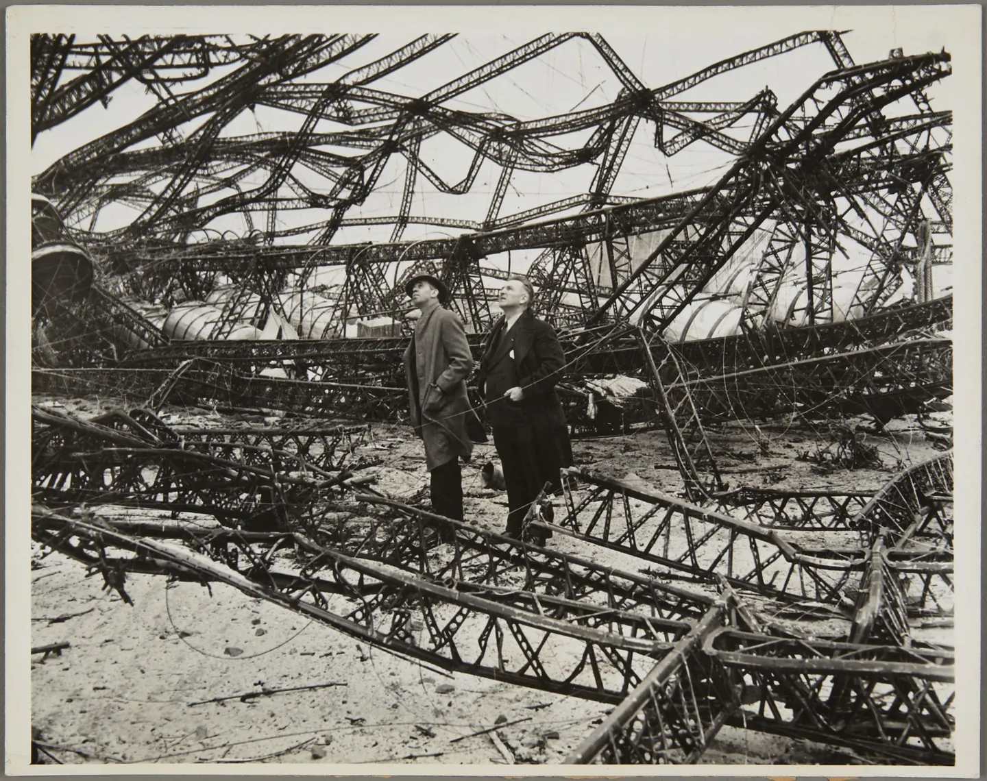 Department of Commerce inspectors George W. Lossow and J. E. Sommers examining Hindenburg’s ruined framework.